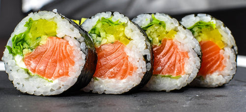 Maki sushi arranged on a table setting