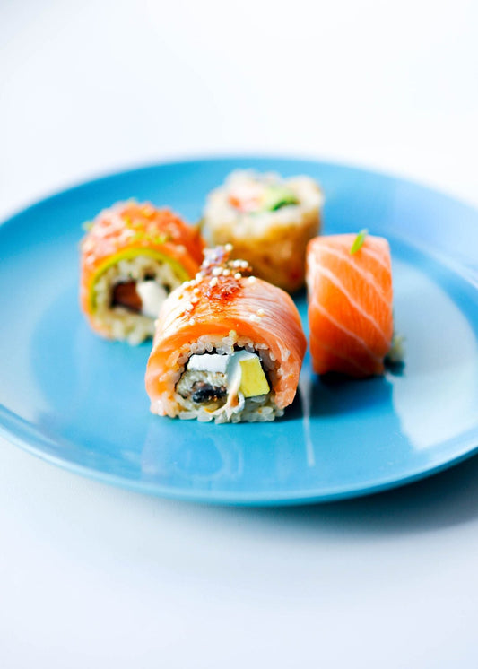 California roll sushi sliced on a plate, showing evenly packed sushi rice