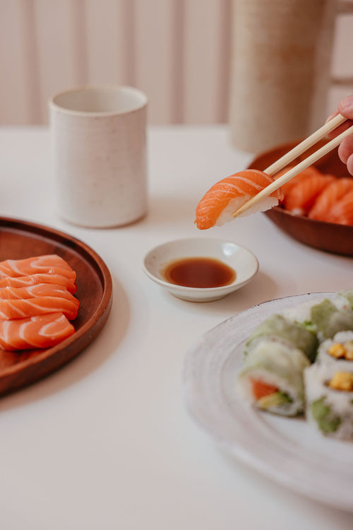 Salmon nigiri close up, showing a slice of raw salmon over rice