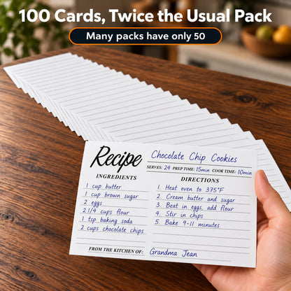 Hand holding a handwritten chocolate chip cookies recipe card above a stack of 100 cards
