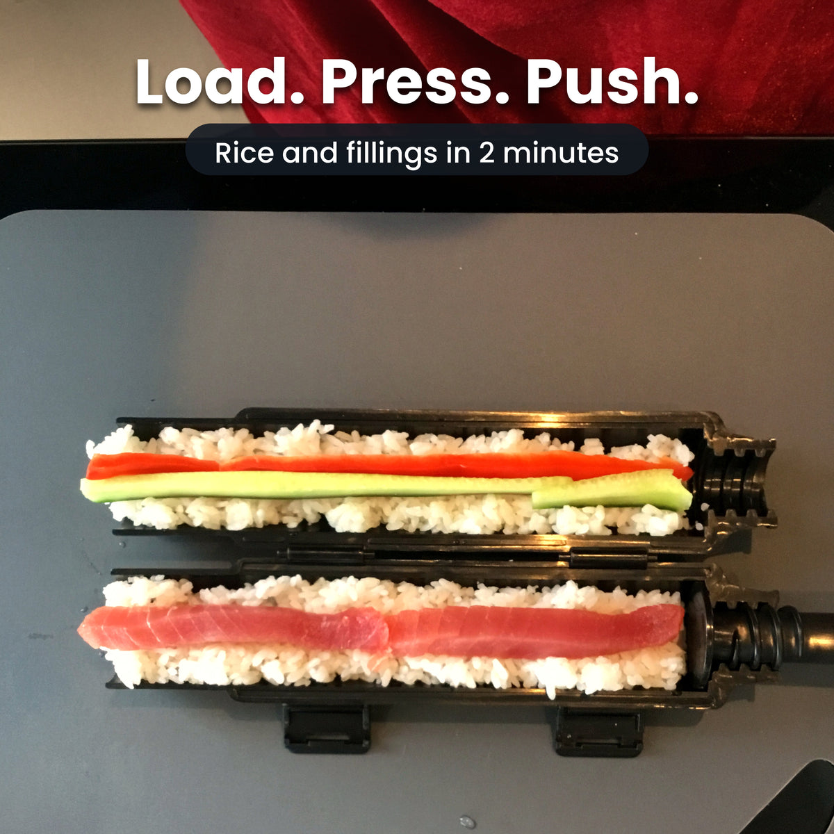 The sushi bazooka opened and loaded with sushi rice, cucumber, pepper and tuna, ready to close and press